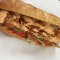 Po Boy Sandwich · Cajun shrimp or fish with a spicy remoulade, shredded lettuce, tomato.
