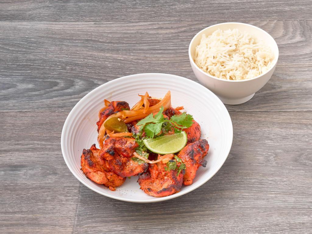 Chicken Tikka Masala Curry · Chicken tikka bruised in a fenugreek-scented tomato cream sauce. Served with rice or naan.