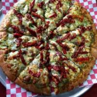 Caprese Chicken Pizza · Fresh baby spinach, roasted chicken, sun-dried tomatoes, red onions, with pesto sauce and mo...