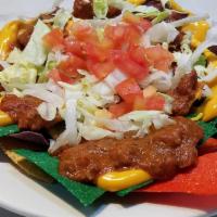 Loaded Nachos · Tri-color corn tortilla chips piled high with chili, topped with cheddar cheese, lettuce, to...