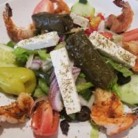Blackened Shrimp Greek Salad · Romaine, tomatoes, cucumbers, onions, peppers, olives, stuffed grape leaves and feta cheese.
