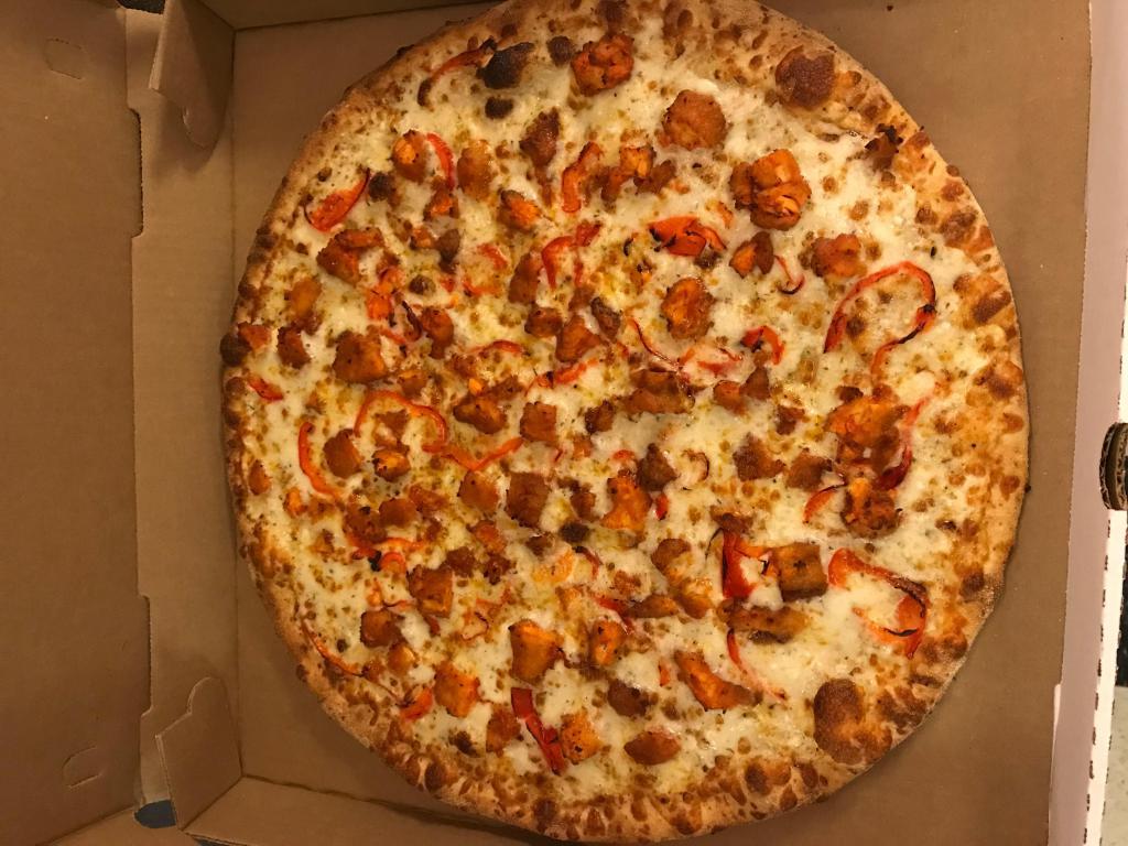 Spicy Buffalo Chicken Pizza · Tender chunks of chicken marinated in a spicy Buffalo wing style sauce, spread out over blue cheese sauce, and combined with sweet roasted red peppers. Spicy.
