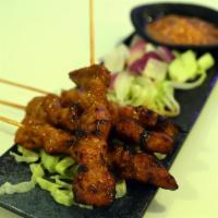 A5. Four Skewers Satay · Marinated beef or chicken on skewers, charcoal-grilled, served with peanut sauce. Spicy.