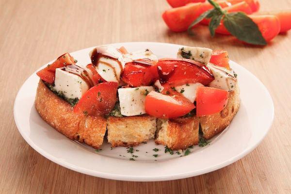Caprese Bruschetta · Fresh mozzarella, vine-ripened tomatoes, basil pesto and balsamic glaze.