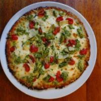 Chicken Pesto Pizza · White pizza with pesto chicken, fresh mozzarella and marinated tomatoes.