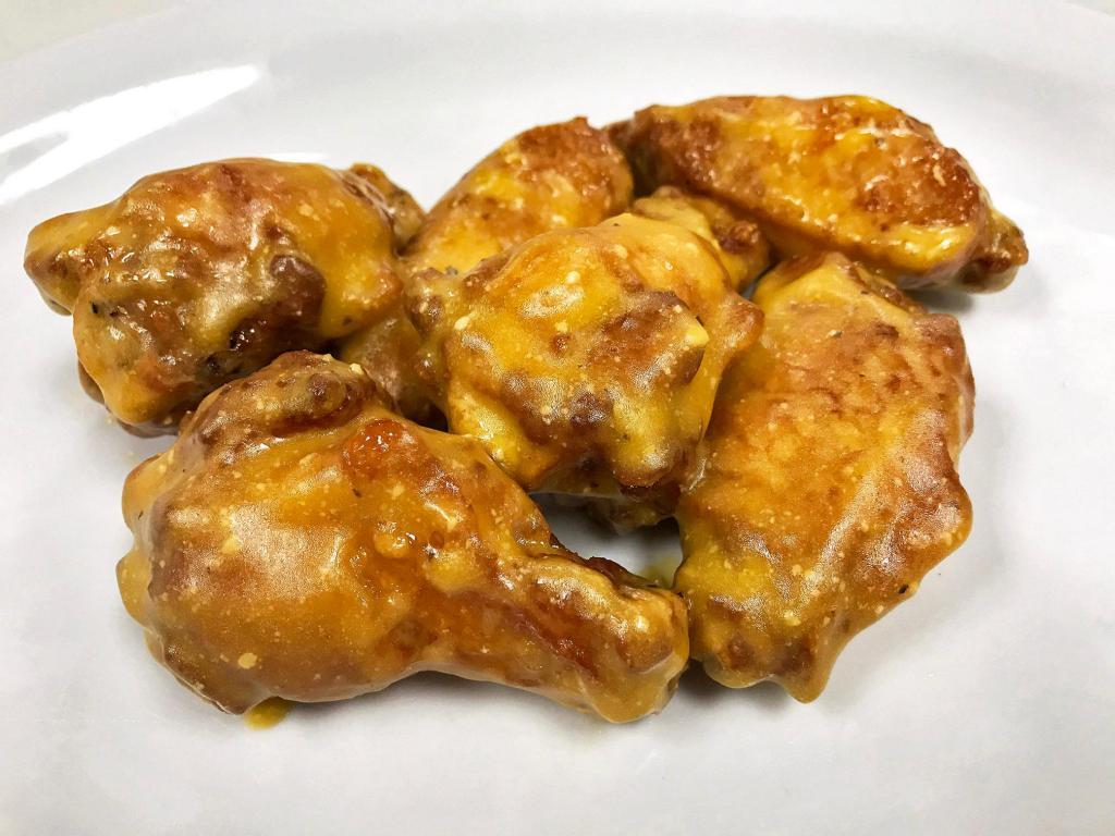 Garlic Chicken Wings · Parmesean –traditional (bone-in) chicken wings hand tossed in a blend of garlic and Parmesan cheese that creates a rich and savory sauce adding creamy depth and deliciousness to every bite.