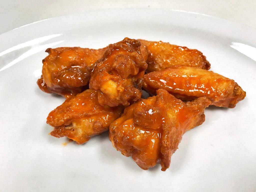 Classic Chicken Wings · Buffalo –traditional (Bone-In) chicken wings hand tossed in a buttery flavor profile with aged cayenne pepper and hints of garlic, creating a savory heat that’s begging to become your favorite wing sauce. Served with a side of Ranch