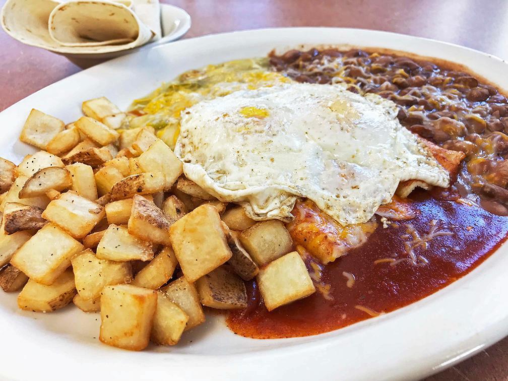Enchilada Rancheros Platter Breakfast · Comes with 2 cheese enchiladas. Served with pan fried potatoes, slow cooked pinto beans, 2 eggs of choice, red or green chile, cheese and a side tortilla. 1150-1170 calories.