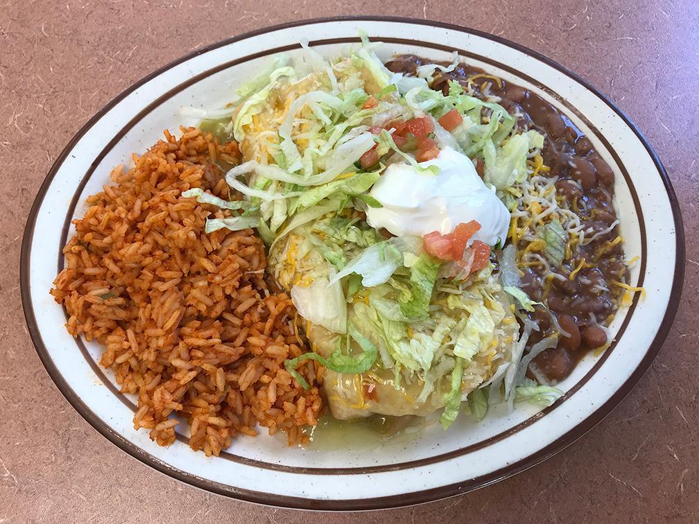 Chimichanga Platter · Crispy fried burrito, choice of meat and chile, topped with topped with cheddar-jack cheese, lettuce and tomato and sour cream. Served with rice and beans. 760-1130 calories.