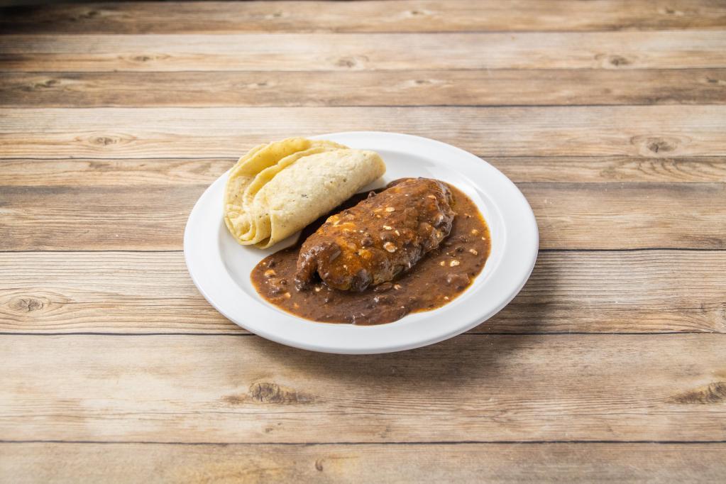 Chile Relleno Clasico · Poblano pepper filled with queso served with tomato salsa, sour cream, refried beans and homemade tortillas. Vegetarian.
