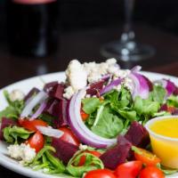 Beet Salad · Sliced beets, baby arugula, crumbled Gorgonzola cheese with a balsamic reduction.