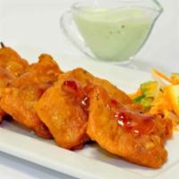 Fish Pakoras GF · Marinated tilapia in corn flour batter and fried, served with sauce.
