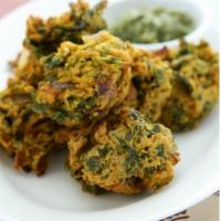 Pakoras GF · Fried spinach and onions fritter with spices with sauce.