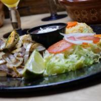 Encebollado Plato · Grilled beef steak topped with grilled onions, served with rice & beans.
