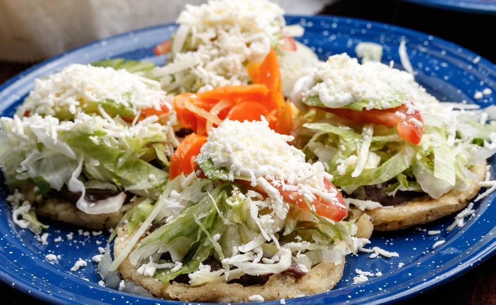 4 Sopes Plato · Topped with beans, shredded beef, lettuce, tomato, onion, avocado, sour cream & queso fresco.