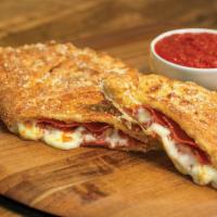 Pepperoni Calzone · Stuffed with pepperoni and our signature 3 cheeses, served with a side of our original pizza...