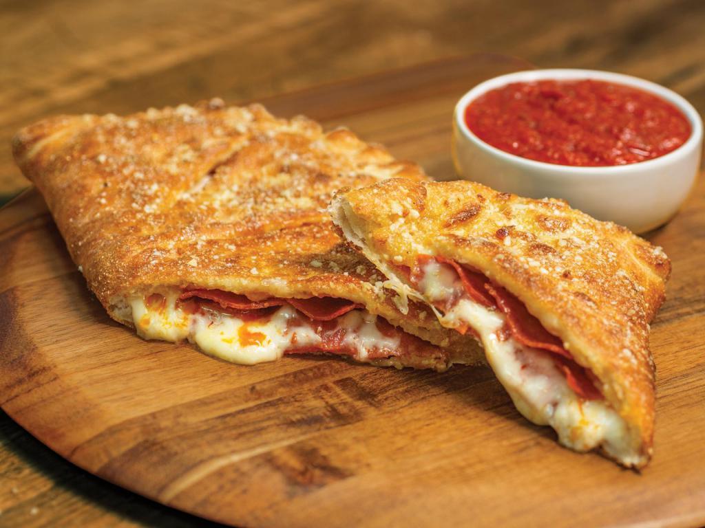 Pepperoni Calzone · Stuffed with pepperoni and our signature 3 cheeses, served with a side of our original pizza sauce.