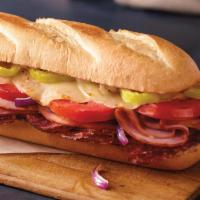 Italiano Sub · Ham, salami, provolone cheese, banana peppers, tomatoes, red onions and sub dressing served ...