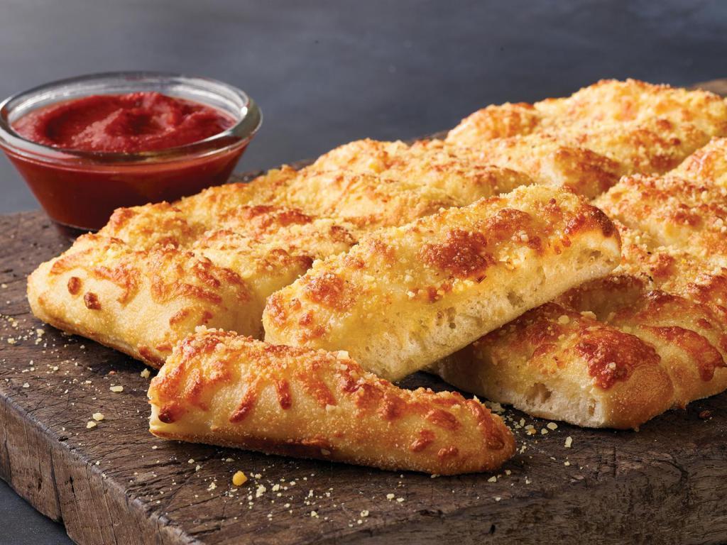 CheezyBread · Fresh-baked bread strips with 3-cheese blend and garlic butter. Served with a side of pizza sauce and ranch dipping sauce.