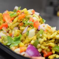 Corn Bhel · Young kernel corn, rice crispy, tomatoes, peppers, potatoes, onions and homemade dressing. V...