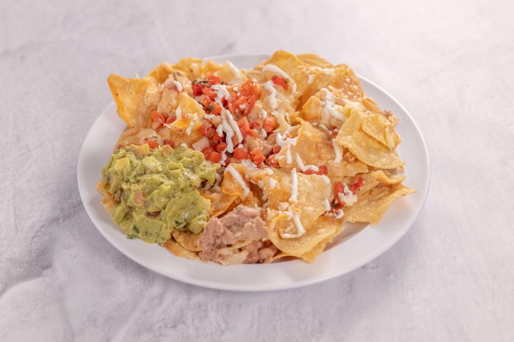 Nachos · Topped with beans, salsa, guacamole and sour cream.