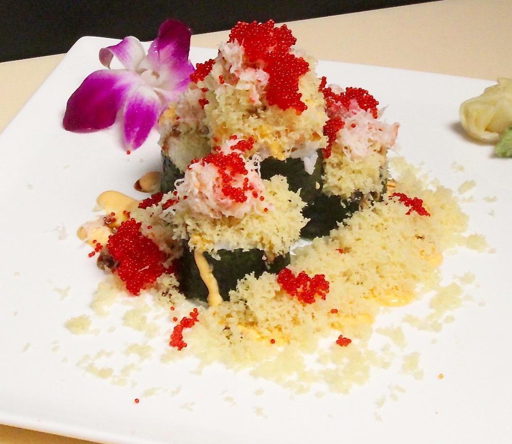 Super Volcano Maki · Salmon, avocado, topped with red crab stick tobiko, tempura crumb scallion, sever with spicy mayo and eel sauce.