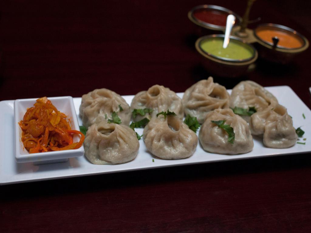 Veg-Momo · 8 pieces steamed or fried vegetable dumpling filled with mixed vegetables, mashed potatoes and spices. Served with dangstel. Vegetarian.