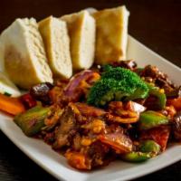 Shapta Beef · Sliced beef stir-fried with garlic, ginger, red onion, green and red bell peppers. Served wi...