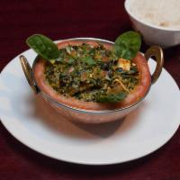 Palak Paneer · Cubes of cottage cheese and spinach cooked in spices and herbs. Served with Jasmine white ri...