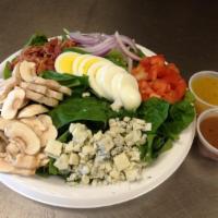 Spinach Salad · Spinach, hard boiled egg, bacon, red onions, diced tomatoes, Gorgonzola cheese, mushrooms.