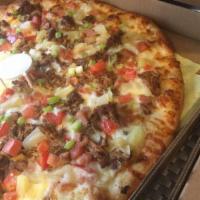 The Street Taco Pizza · Monterey Jack cheese blend, carnitas (slow cooked pork), avocado and red onions over a chili...