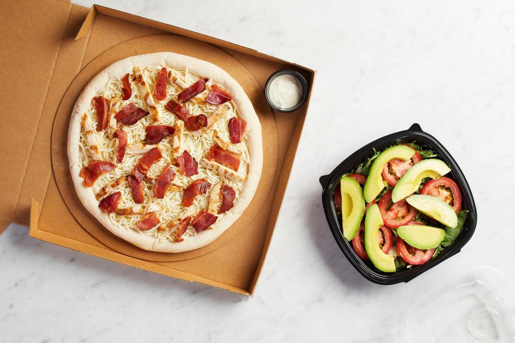 Take and Bake California Club Pizza  · READY TO BAKE - Nueske's applewood smoked bacon, grilled chicken and mozzarella, hearth-baked then topped with avocado, wild arugula, fresh tomatoes, torn basil and Romaine tossed in lemon-pepper mayo.