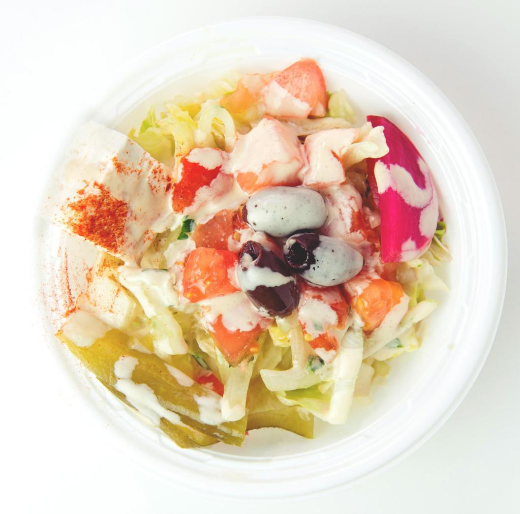 Mamoun's Salad · Lettuce, tomatoes, onions, pickles, pickled turnips, olives, feta cheese, grape leaf, lemon juice, olive oil, and tahineh sauce