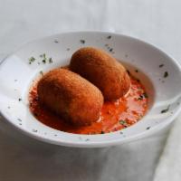 Arancini di Riso · Sicilian rice croquettes stuffed with prosciutto and fresh mozzarella served in tomato cream...