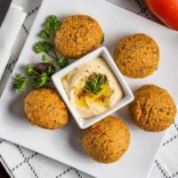 Falafel · Ground garbanzo and fave beans are spiced, mixed with vegetables and fried to a crispy golde...