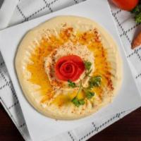 Hummus · A tasty mix of garbanzo beans with a touch of garlic, lemon juice and tahini sauce, topped w...