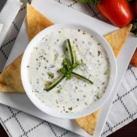 Taziki Sauce · Yogurt mixed with garlic, mint and cucumber topped with olive oil and a dash of dried mint. ...