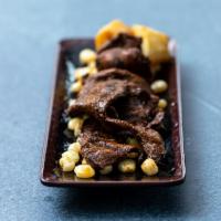 ANTICUCHOS · Beef heart marinated with Aji Panca, traditionally served with a slice of potato and choclo....