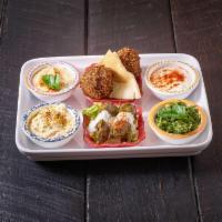 Veggie Plat · 2 falafel, 2 dolma, hummus, piyaz, tzatziki, baba ghannouj, and tabbouleh.