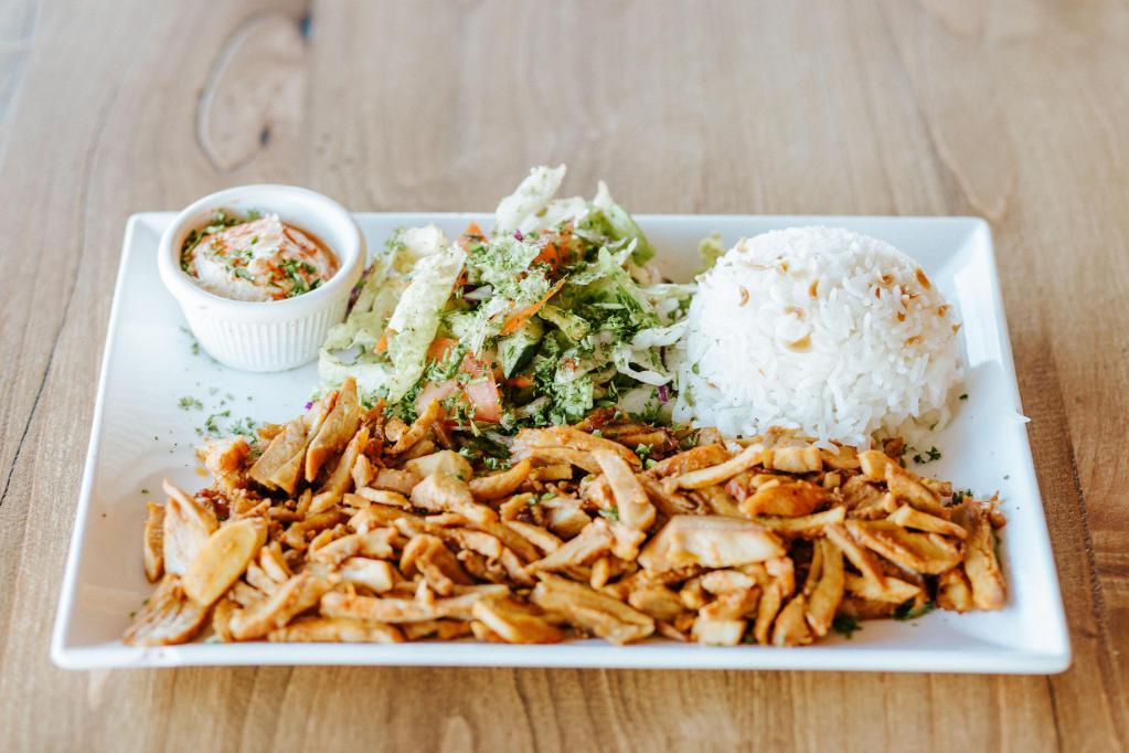 Chicken Shawarma Platter · Slowly-roasted thinly-sliced chicken.  Served with rice, salad, hummus and pita bread.  
