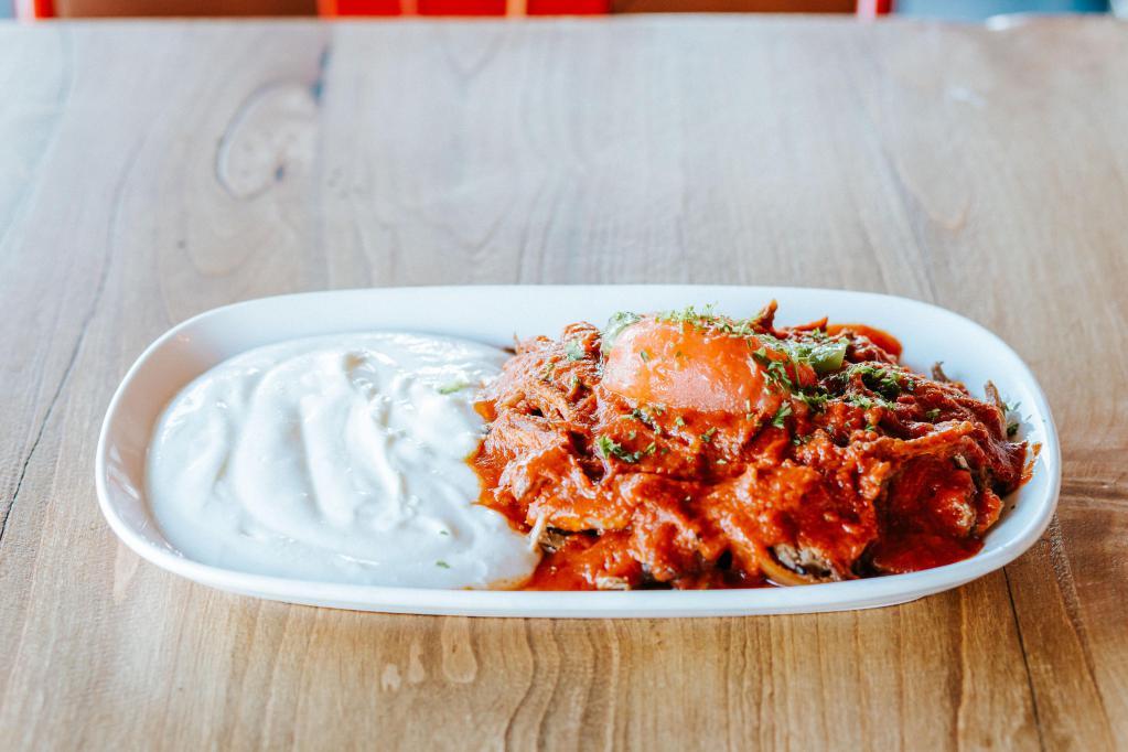 Iskender Kebab Platter · Thinly-sliced roasted lamb served over sliced pita, covered in a tomato and butter sauce.  Served with a generous portion of yogurt.  Served with rice, salad, hummus and pita bread.
