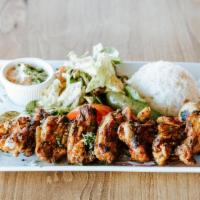 Grilled Chicken Wings Platter · Served with rice, salad, hummus and pita bread.
