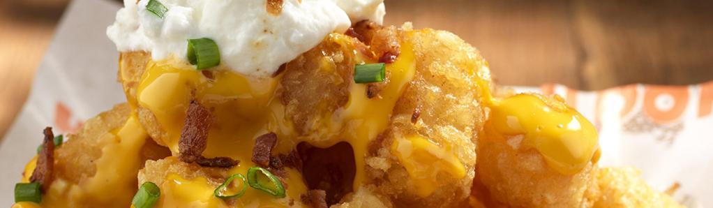 Lots-a-Tots · A mountain of tots covered with bacon, cheese, sour cream and green onions. 