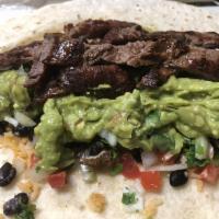 Millionaire burrito · 1/2 pound grilled steak, fresh guacamole, black beans, rice, onions, cilantro, and  chips an...