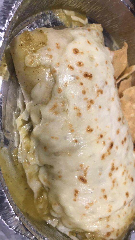 Wet Grilled Chicken Burrito green · Grilled chicken, onion, cilantro, rice and black beans, melted mozzarella cheese and salsa .with chips on the side.