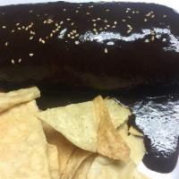 Mole Negro Burrito · Chicken breast with our famous mole sauce, rice, black beans, onions, and sesame seeds.chips...