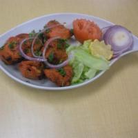 Chicken Boti · 6 pieces of chicken grilled in tandoor. Served with salad and tandoori naan.