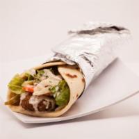 13. Falafel Wrap · Served with lettuce, tomatoes, onions, pickles, tahini and garlic sauce. Served with choice ...