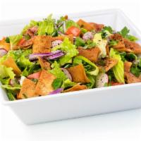 Fattoush Salad · Lettuce, tomatoes, onions, cucumbers, parsley, sumag and pita chips. Vegetarian.