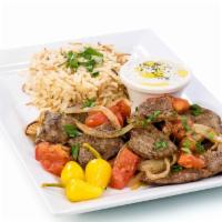 Gyros Plate · Traditional Greek gyro meat mixed with grilled onions and tomatoes served with choice of side.